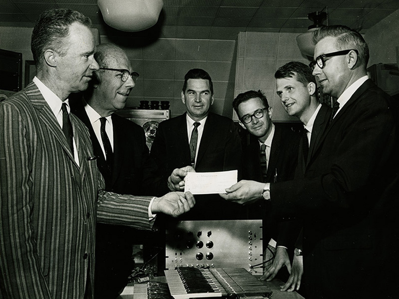 Beauchamp and other professors accepting a sponsorship check from a MagnaVox executive